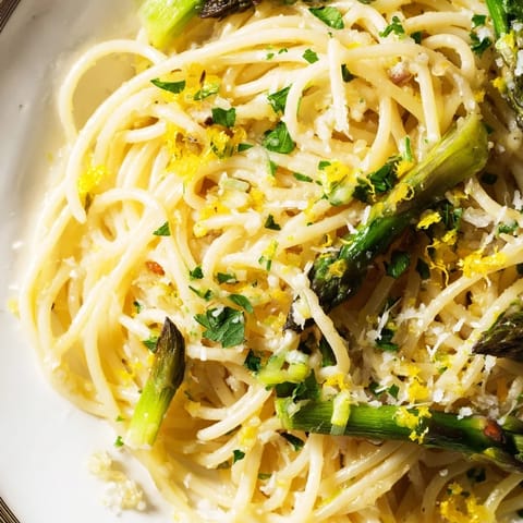 Freshly grated Parmesan and lemon zest add a savory, tangy finish to this simple, aromatic spring pasta meal.