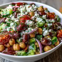 Close-up of Greek Bean Salad with Lemon Marinated Beans, featuring creamy feta and vibrant red tomatoes.