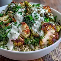 Golden roasted broccoli, cauliflower, and Brussels sprouts mingle with fluffy quinoa in this nourishing Roasted Brassica Bowl.
